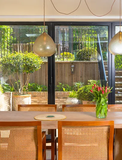 Bespoke house extension in London by trusted builders, creating bright open-plan living space with garden views.