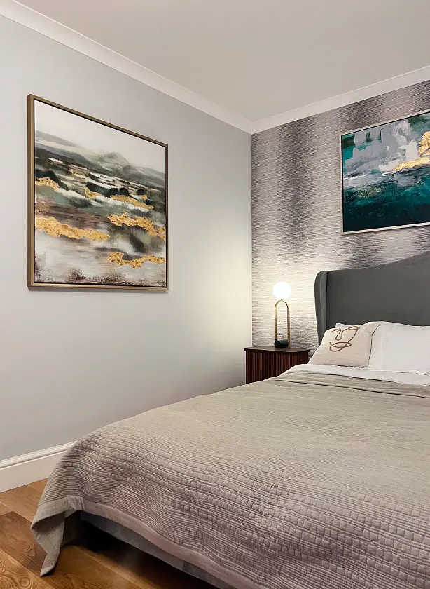 Detail of Kensington apartment renovation bedroom with modern wall art and neutral finishes.
