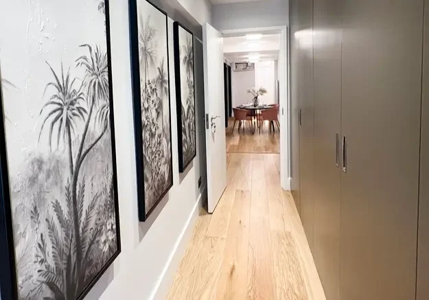 Basement conversion in London with bespoke hallway storage and modern artwork.