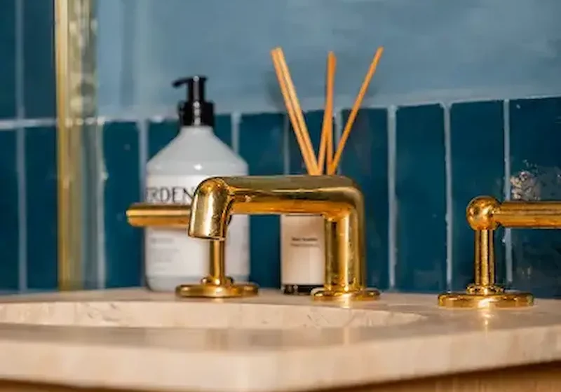 Builders in Chelsea delivering a luxury bathroom renovation with brass fittings and tiled walls.