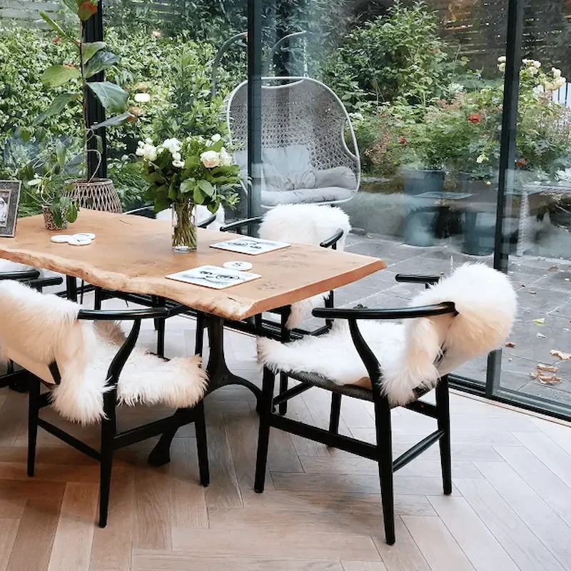 Builders in Chelsea constructing a glass extension with oak flooring and garden-facing dining area.