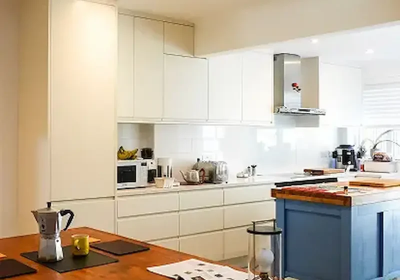 Builders in Chelsea designing and constructing a bespoke modern kitchen with island and cabinetry.