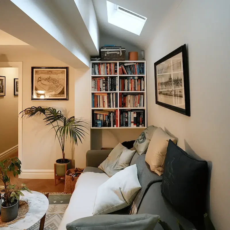 Builders in Chelsea creating elegant basement living space with custom joinery and soft ambient lighting.
