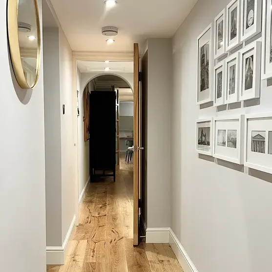 Builders in Kensington completing a modern living room renovation with bespoke shelving, natural light, and luxury finishes.