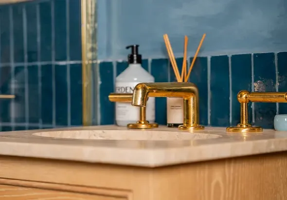 builders in Fulham bathroom renovation with gold tap and marble countertop