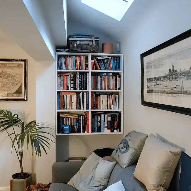 Terrace house renovation in Chelsea with skylight lounge and integrated bookcase.