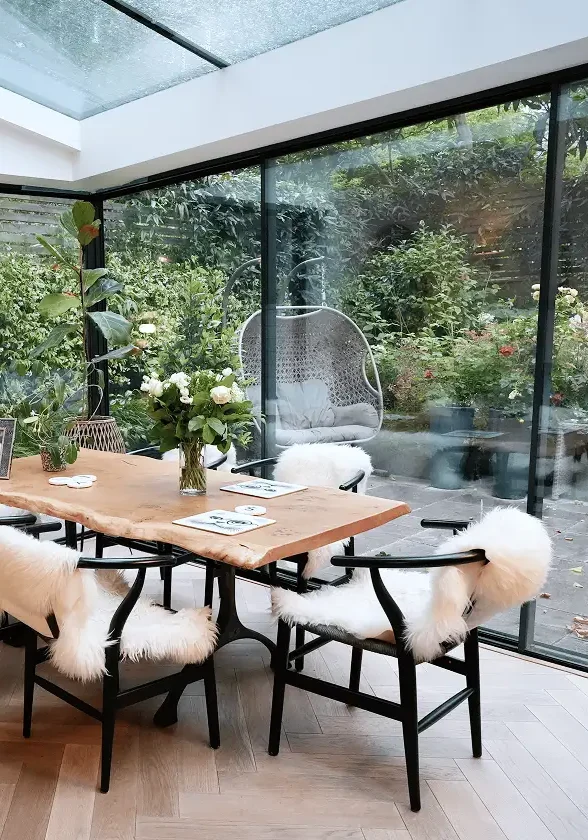 Terrace house renovation in Chelsea with dining area opening to garden.