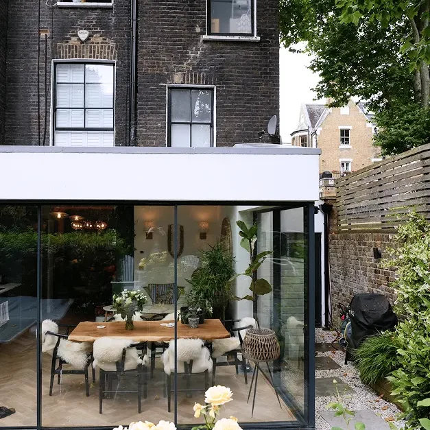 Terrace house renovation in Chelsea with glass extension overlooking landscaped garden.