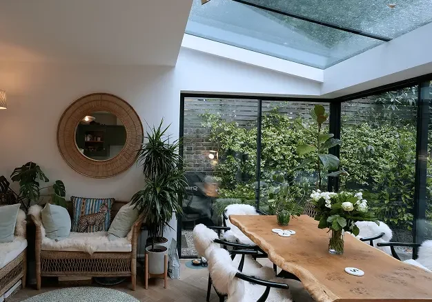 Terrace house renovation in Chelsea featuring rear glass extension blending modern and period architecture.