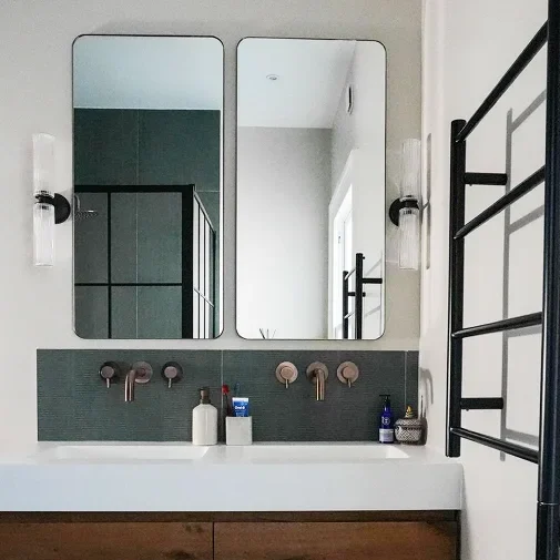 Victorian house refurbishment in Fulham with bathroom twin mirrors and tiled walls.
