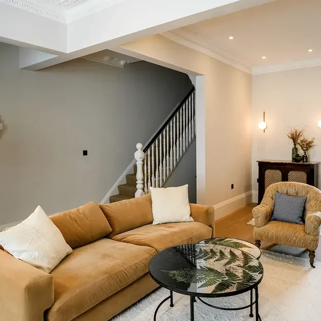 Victorian house refurbishment in Fulham with mustard sofa and staircase detail.