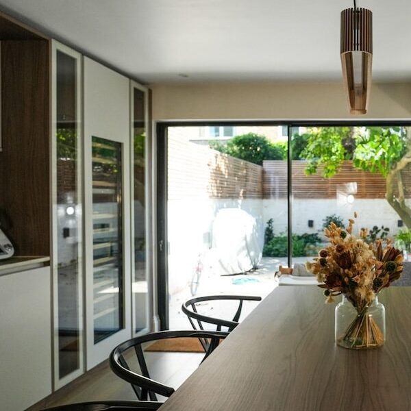 Kitchen and services upgraded as part of a Notting Hill home renovation, with glazing onto the garden.