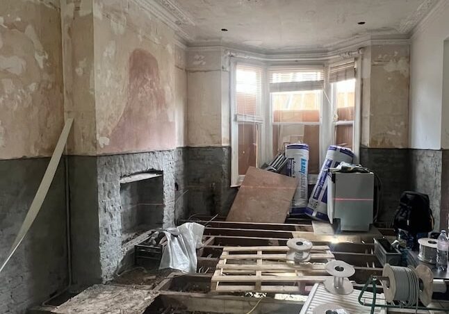 Period property renovation in progress, with floors opened and original room features exposed.