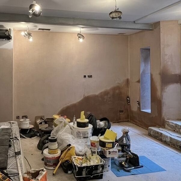 Room under renovation with plaster repairs and building fabric works before decoration.