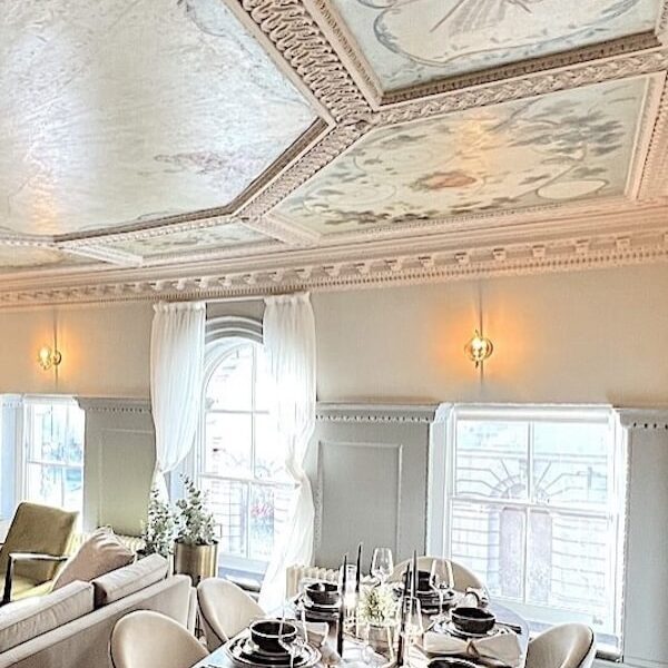 Restored decorative ceiling and dining room details in a period home renovation.