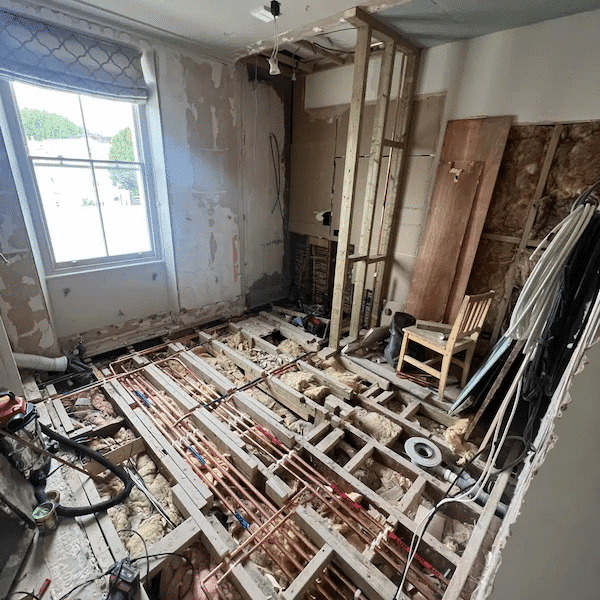 Structural alterations during a Notting Hill home renovation, with floors opened and services exposed.