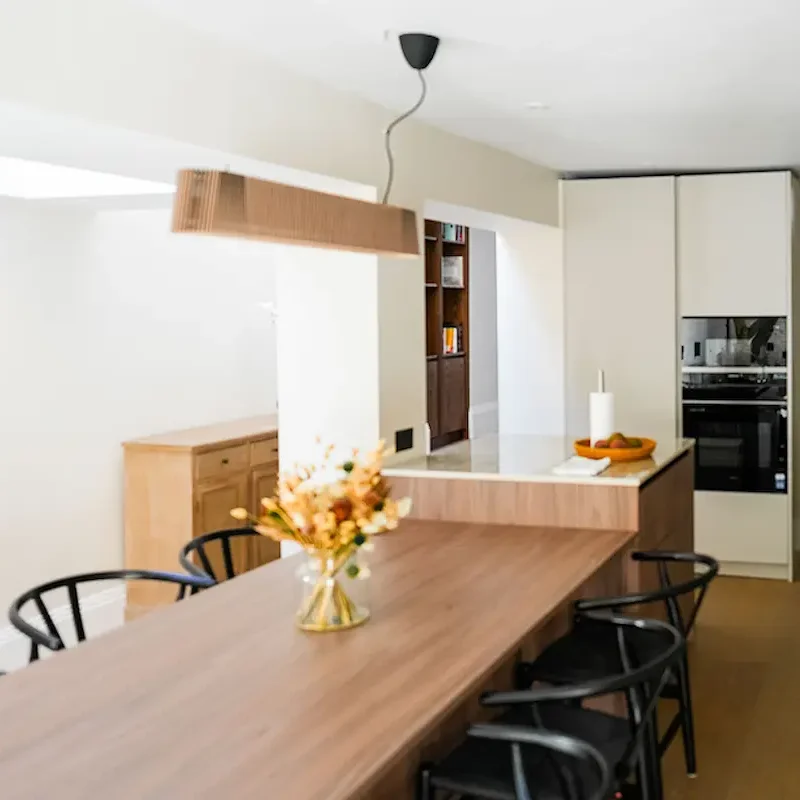House extensions London with open-plan kitchen and wood island dining space.