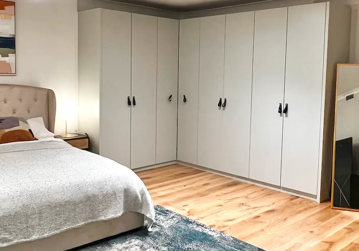 Renovated Kensington apartment bedroom with fitted wardrobes and contemporary design.