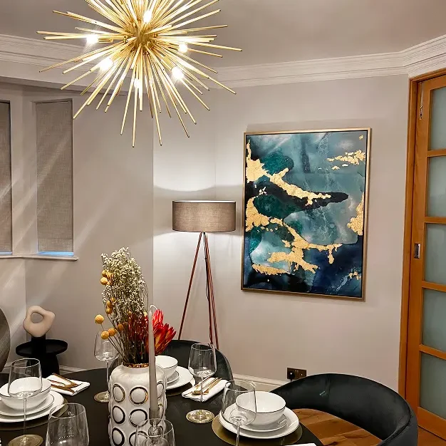 Apartment renovation in Kensington with statement chandelier and contemporary dining area.