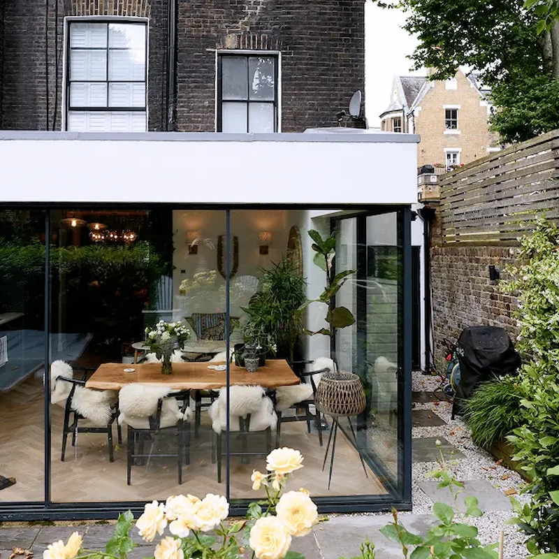 Glass extension with natural light and wooden furniture as part of kitchen renovation London Chelsea project.