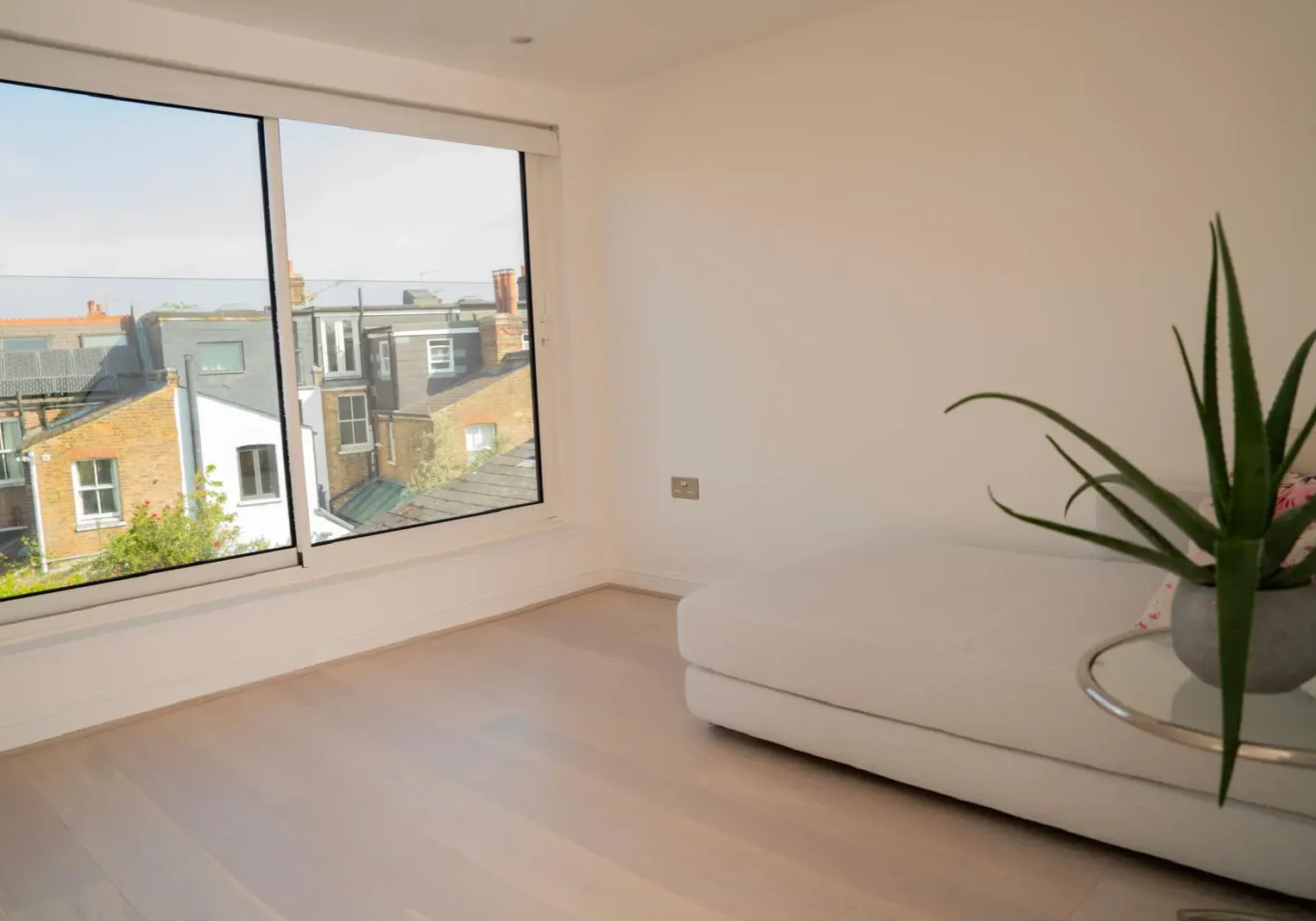 Loft conversion London with large modern windows and neutral interiors designed for natural light