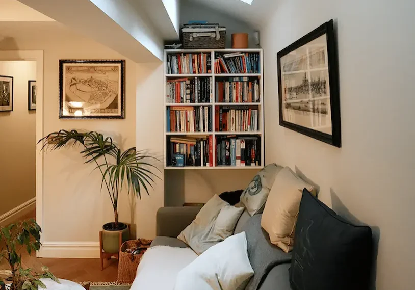 Loft conversion London with cosy reading nook, skylight, and bespoke bookshelves.