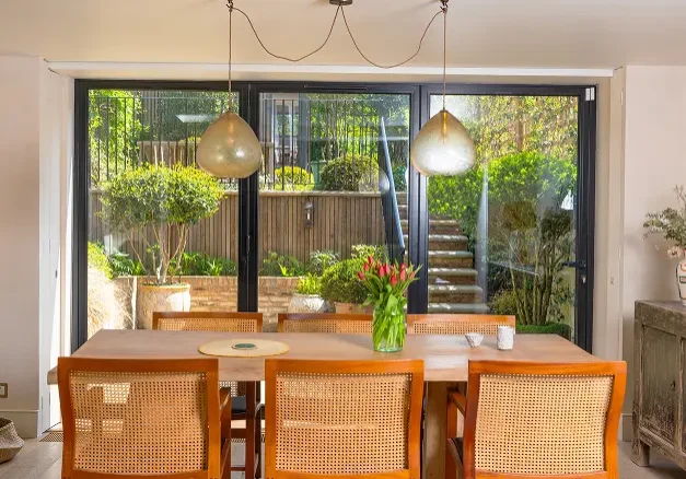 Builders in Notting Hill constructing a bright house extension with sliding glass doors and garden access.