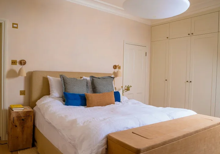 Master bedroom in Notting Hill Victorian house renovation with bespoke fitted wardrobes.