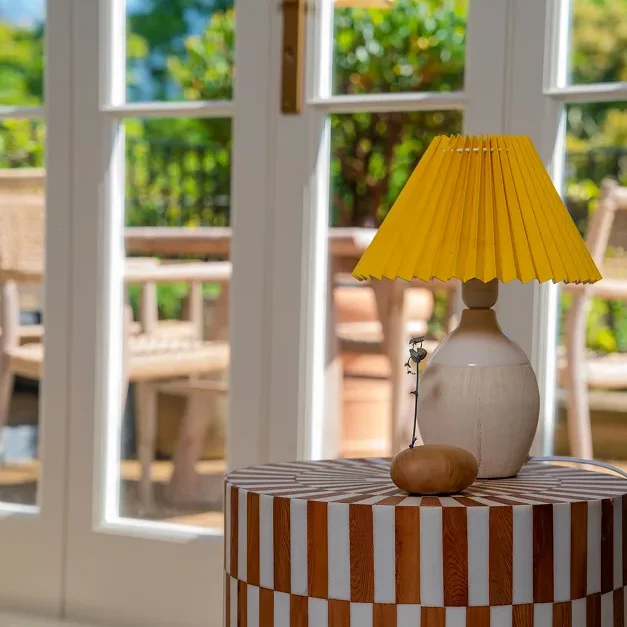 Notting Hill Victorian house renovation interior with striped side table and yellow lamp.