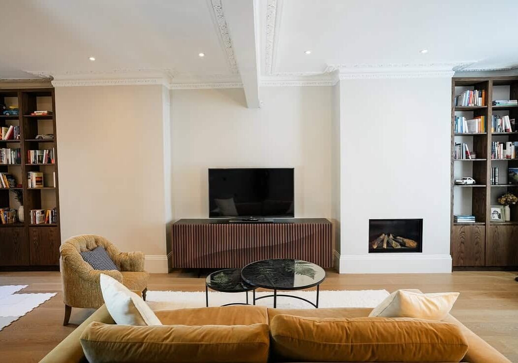 Period property renovation London – Georgian living room refurbishment with bespoke joinery, restored cornicing and contemporary finishes.